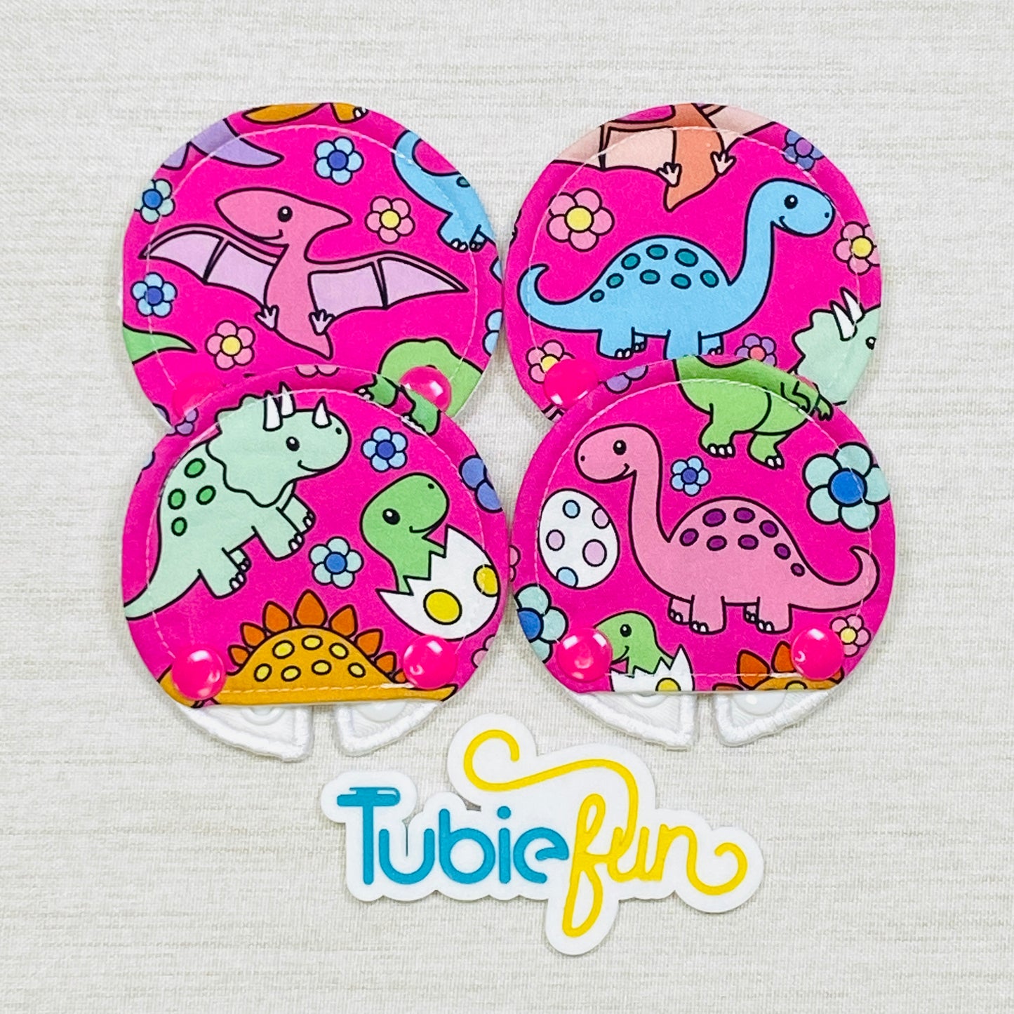 Covered Button Pad - Coloured Dinosaurs on Pink